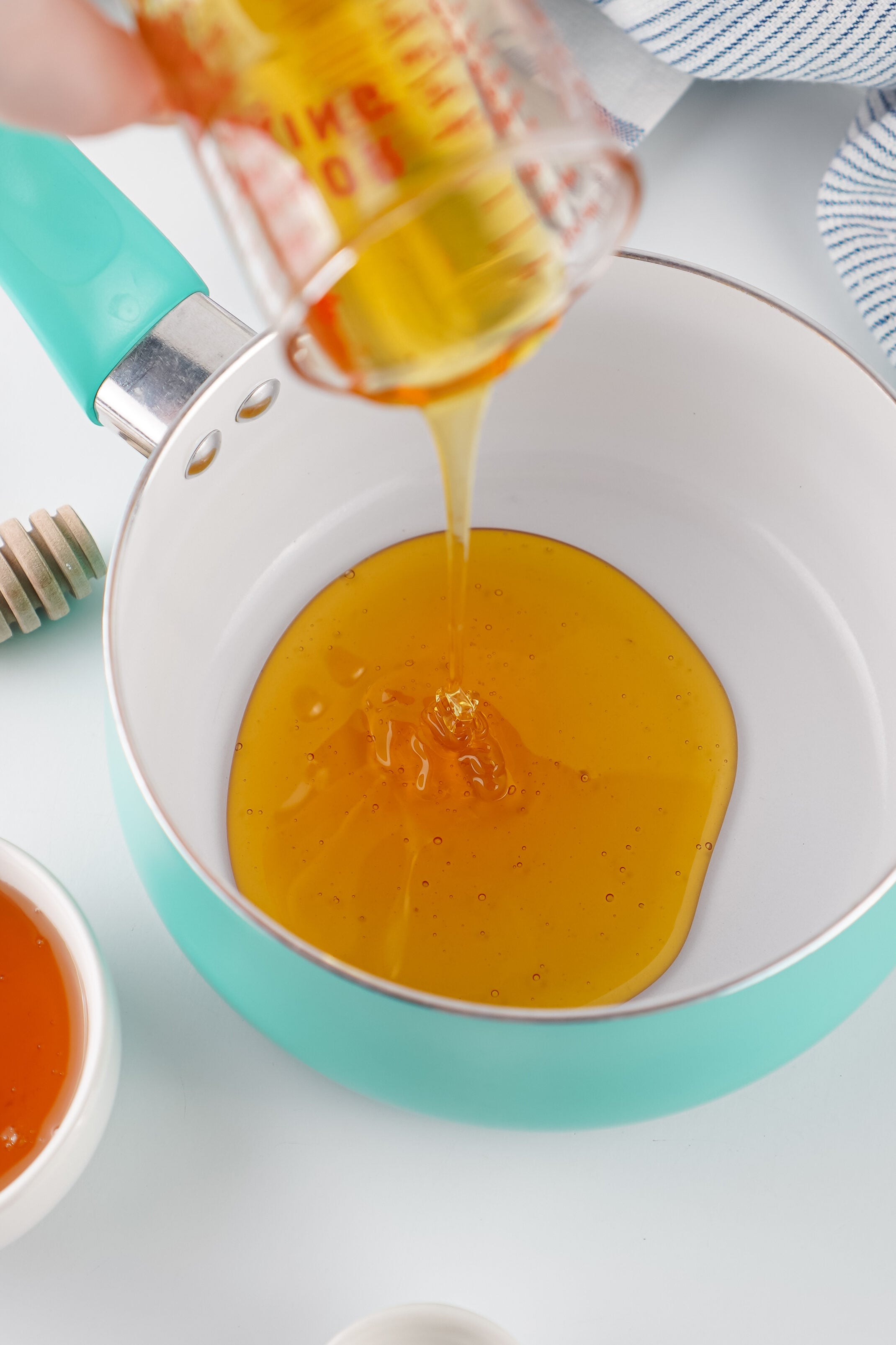 drizzling honey into a pot