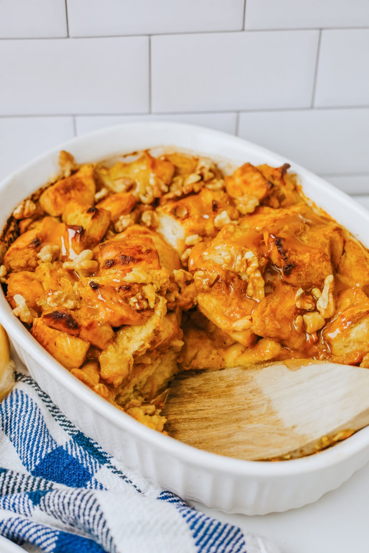 a dish of pumpkin bread pudding with a spoonful missing
