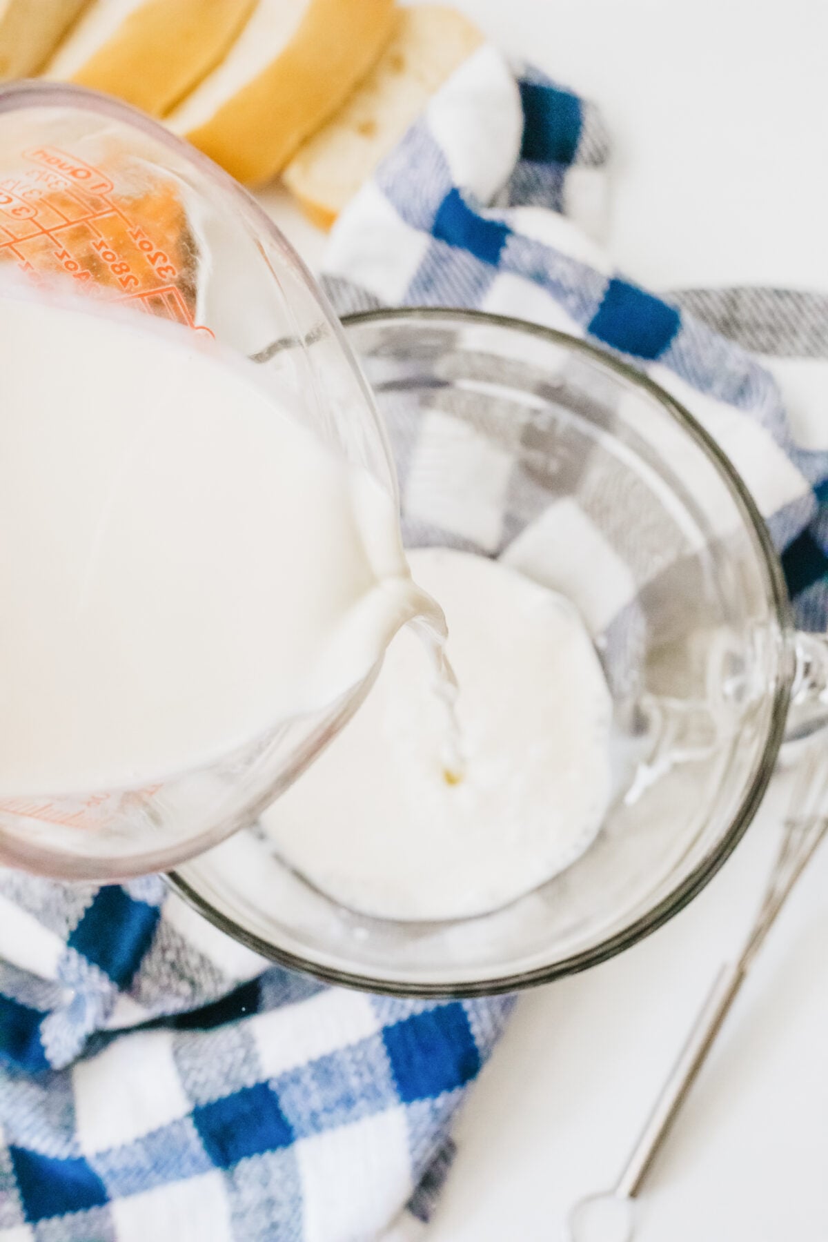 pouring milk into a mixing bowl
