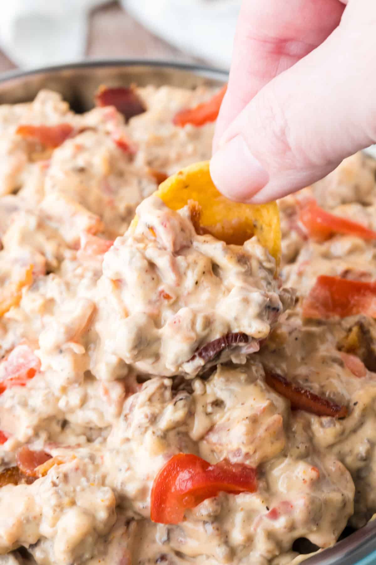 dipping bacon cheeseburger dip with a frito