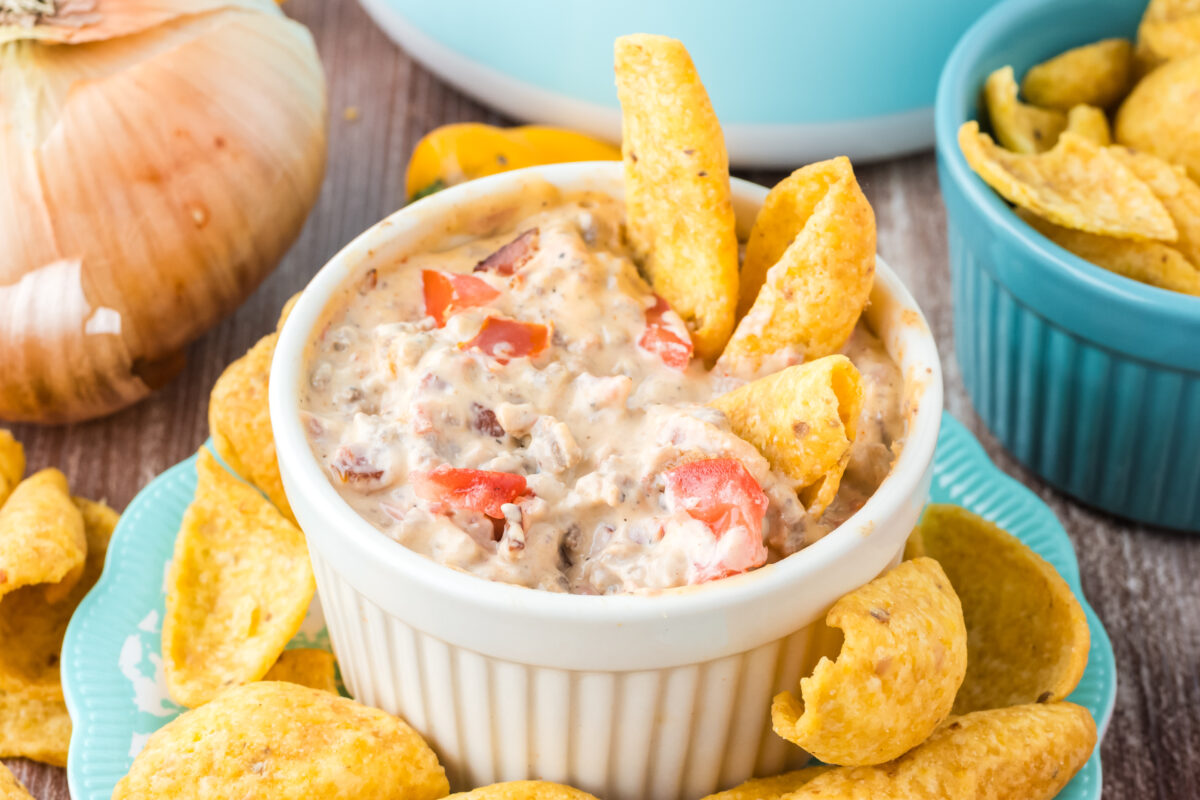 bacon cheeseburger dip with fritos in the bowl
