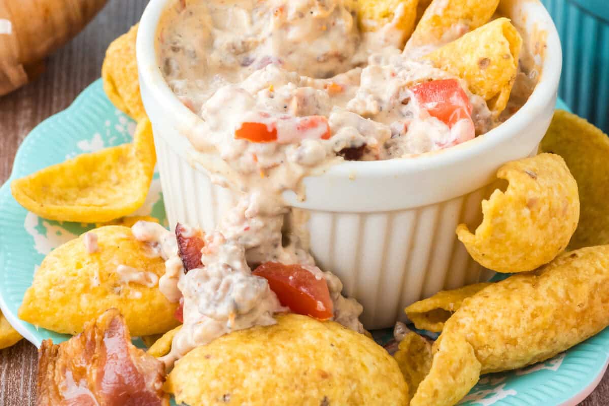 cheeseburger bacon dip spilling over dish