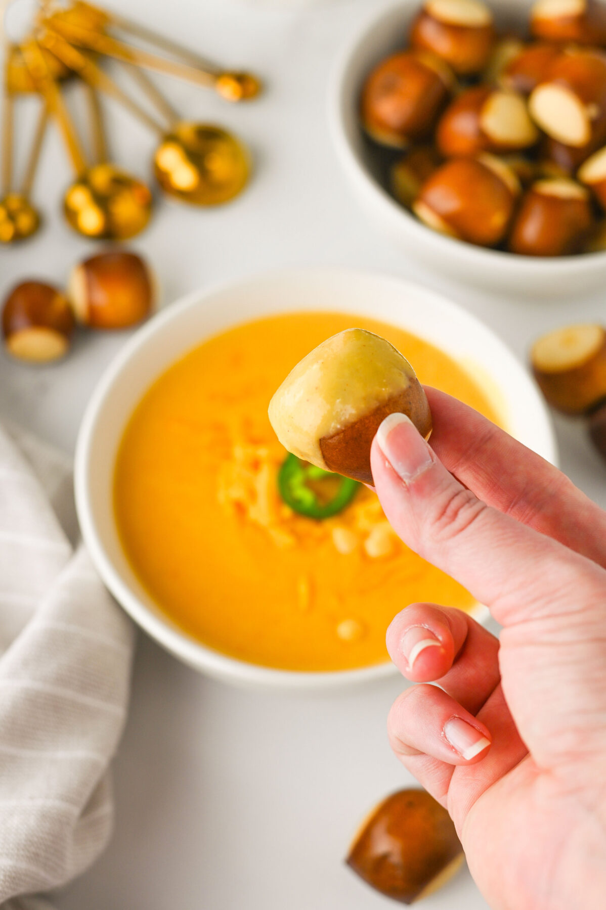 beer cheese dip on a pretzel bite