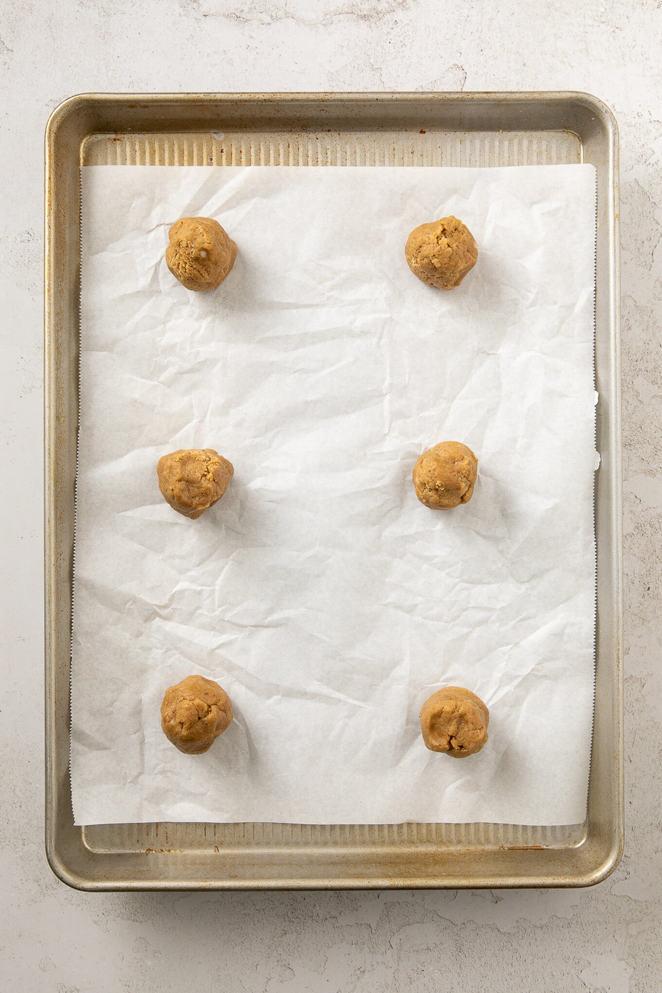 cylinders of cookie dough on a baking sheet