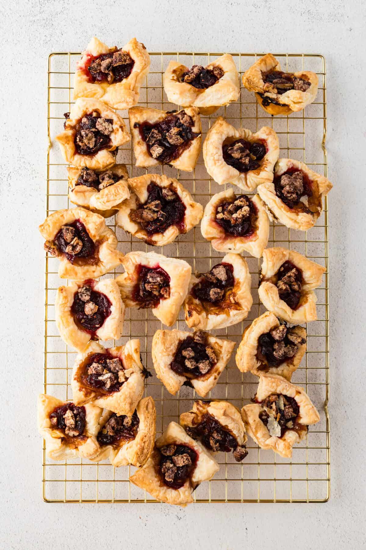springs of rosemary added to cranberry brie bites