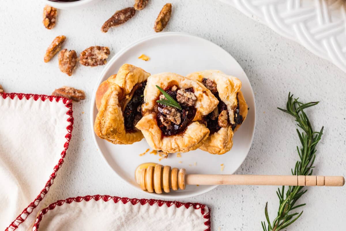 cranberry brie bites on a plate with a honey comb