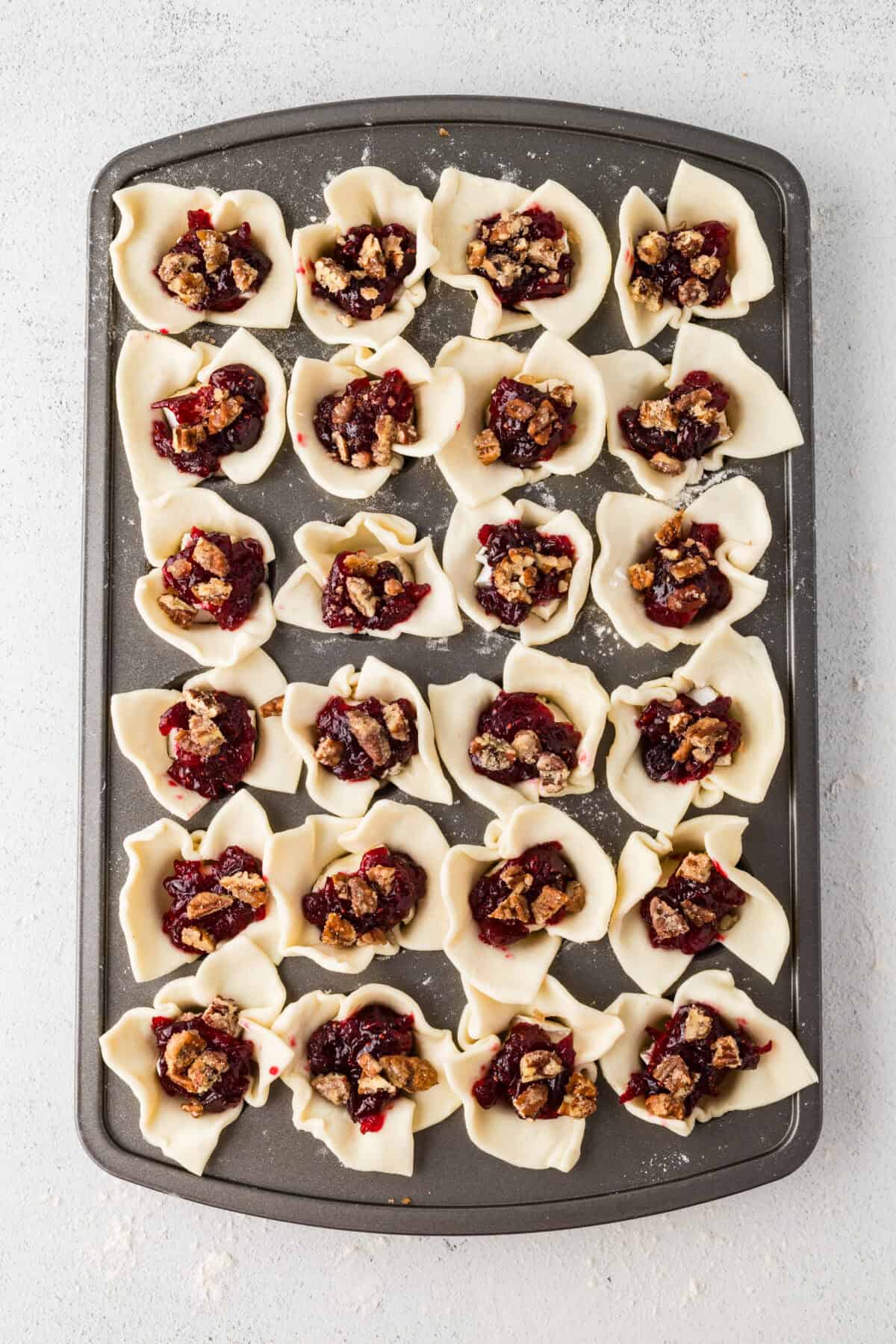 chopped spiced pecans added on top of the cranberry brie bites