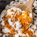a wooden spoon full of crockpot sweet potato casserole