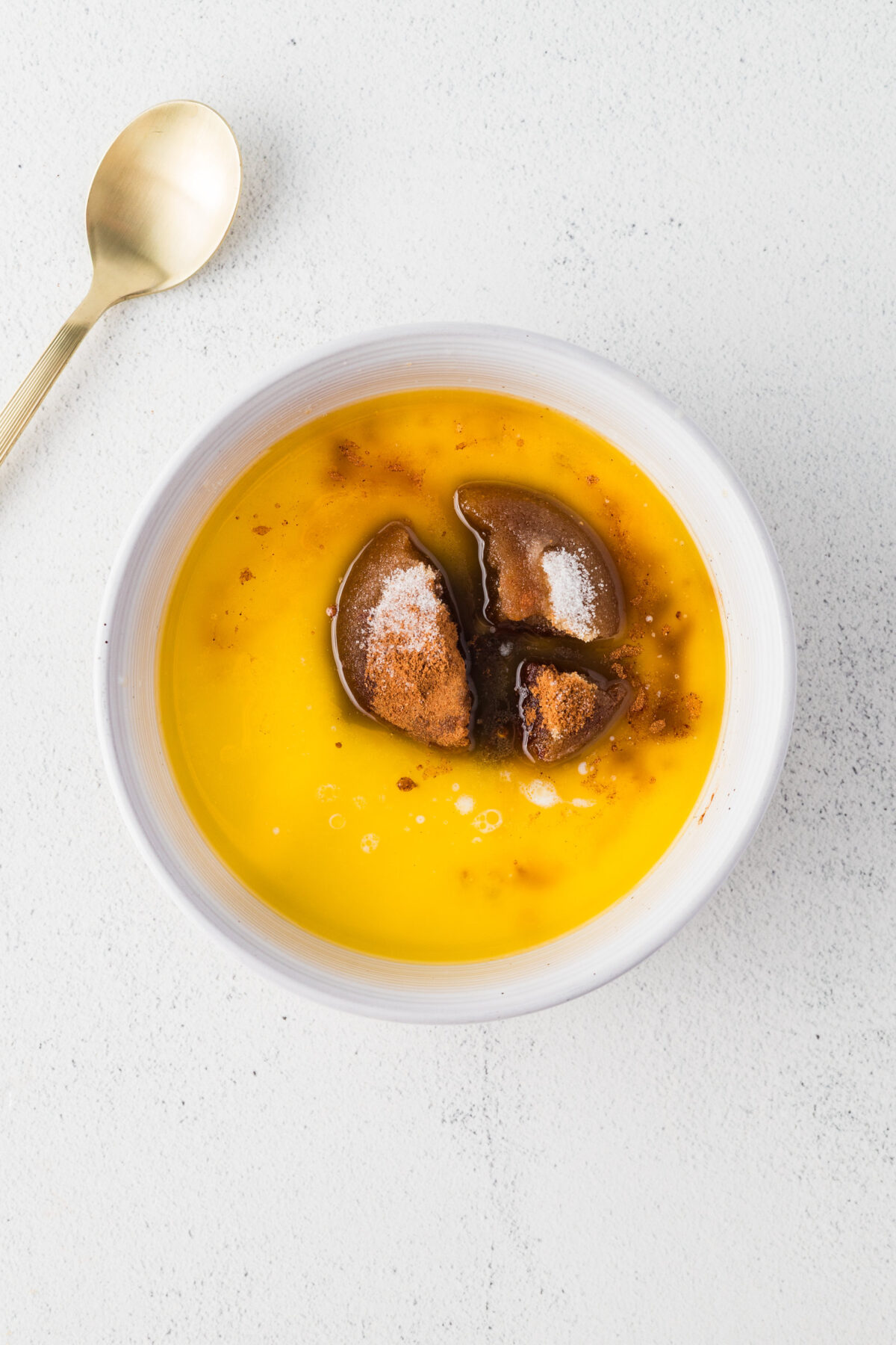  melted butter, brown sugar, heavy cream, maple syrup, salt, and pumpkin pie spice in a mixing bowl