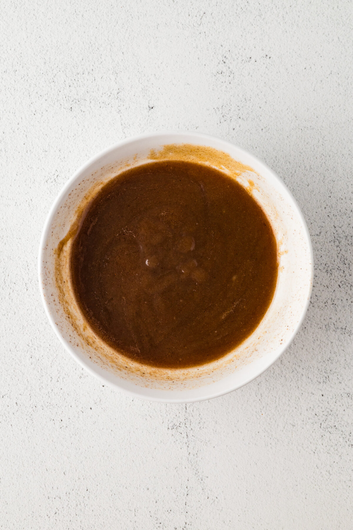  melted butter, brown sugar, heavy cream, maple syrup, salt, and pumpkin pie spice mixed up in a mixing bowl