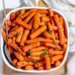 roasted baby carrots in a white dish