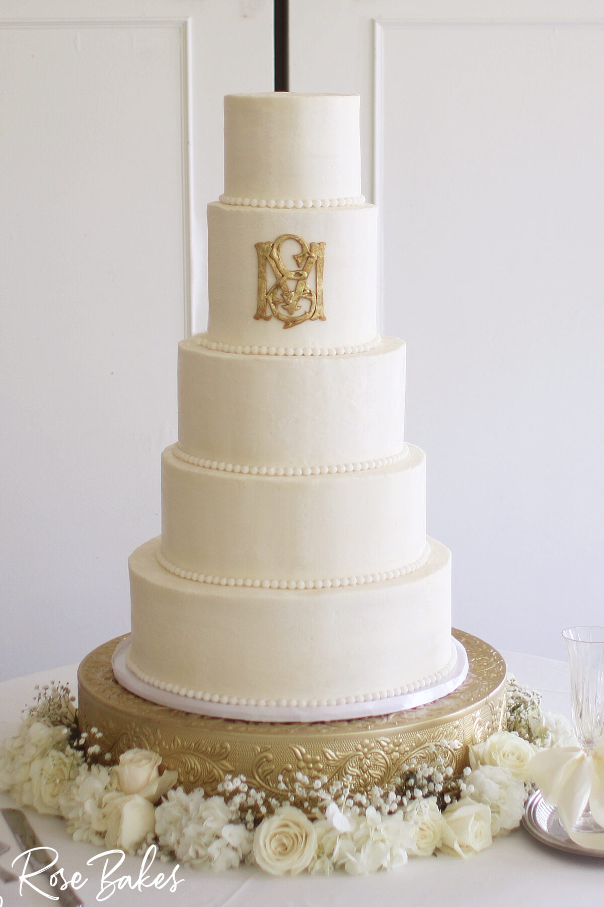 wedding cake with gold monogram