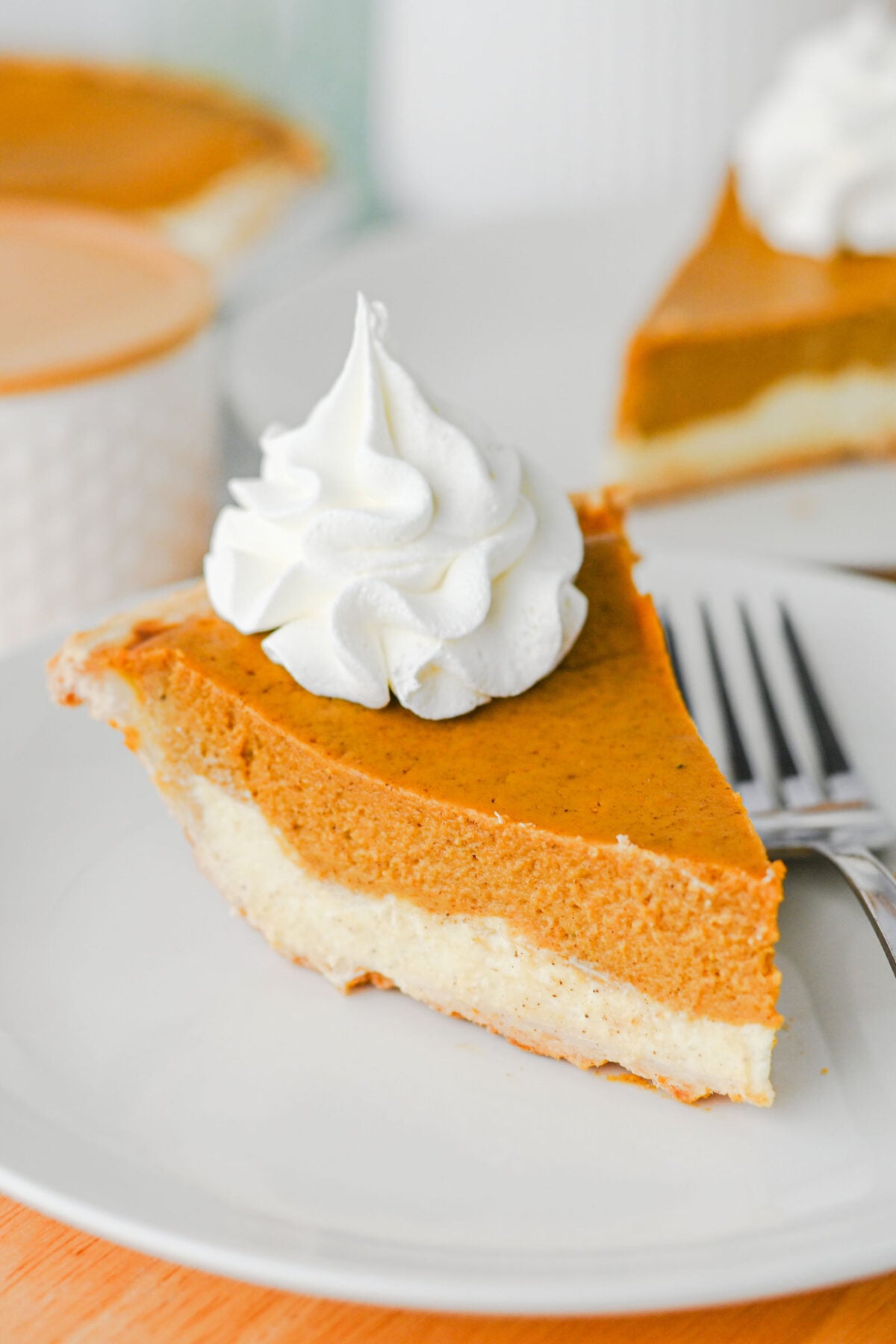 Slice of Pumpkin Cheesecake Pie on a white plate