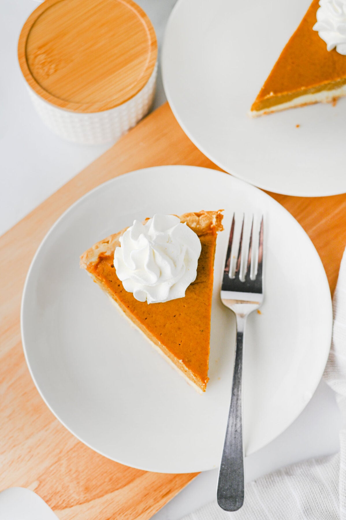 Slice of Pumpkin Cheesecake Pie on a white plate