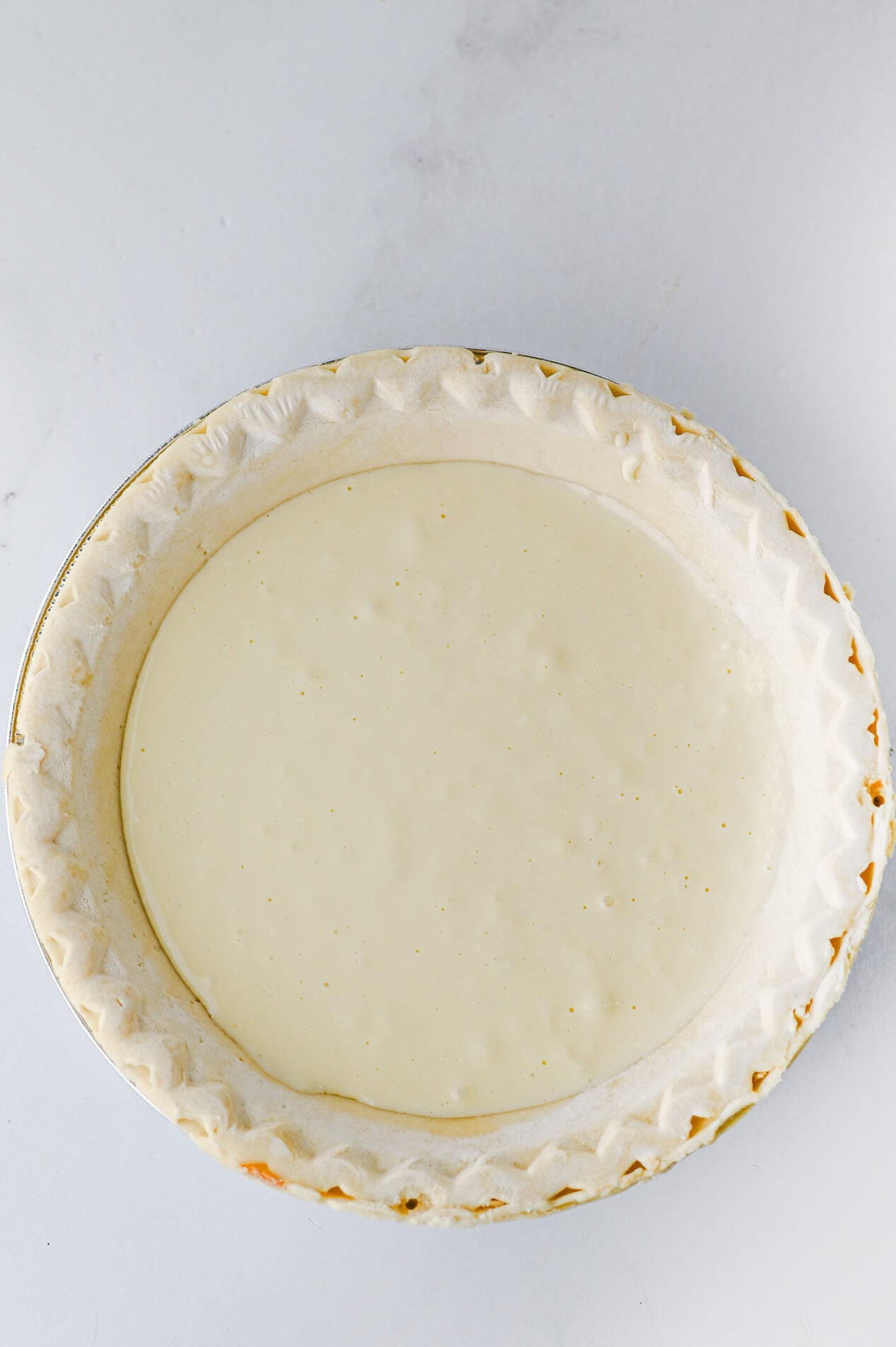cheesecake mixture in a deep dish pie crust