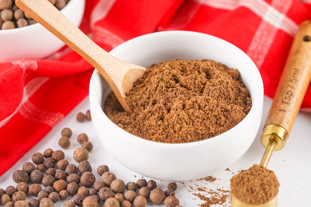 ground allspice in a bowl with a spoon