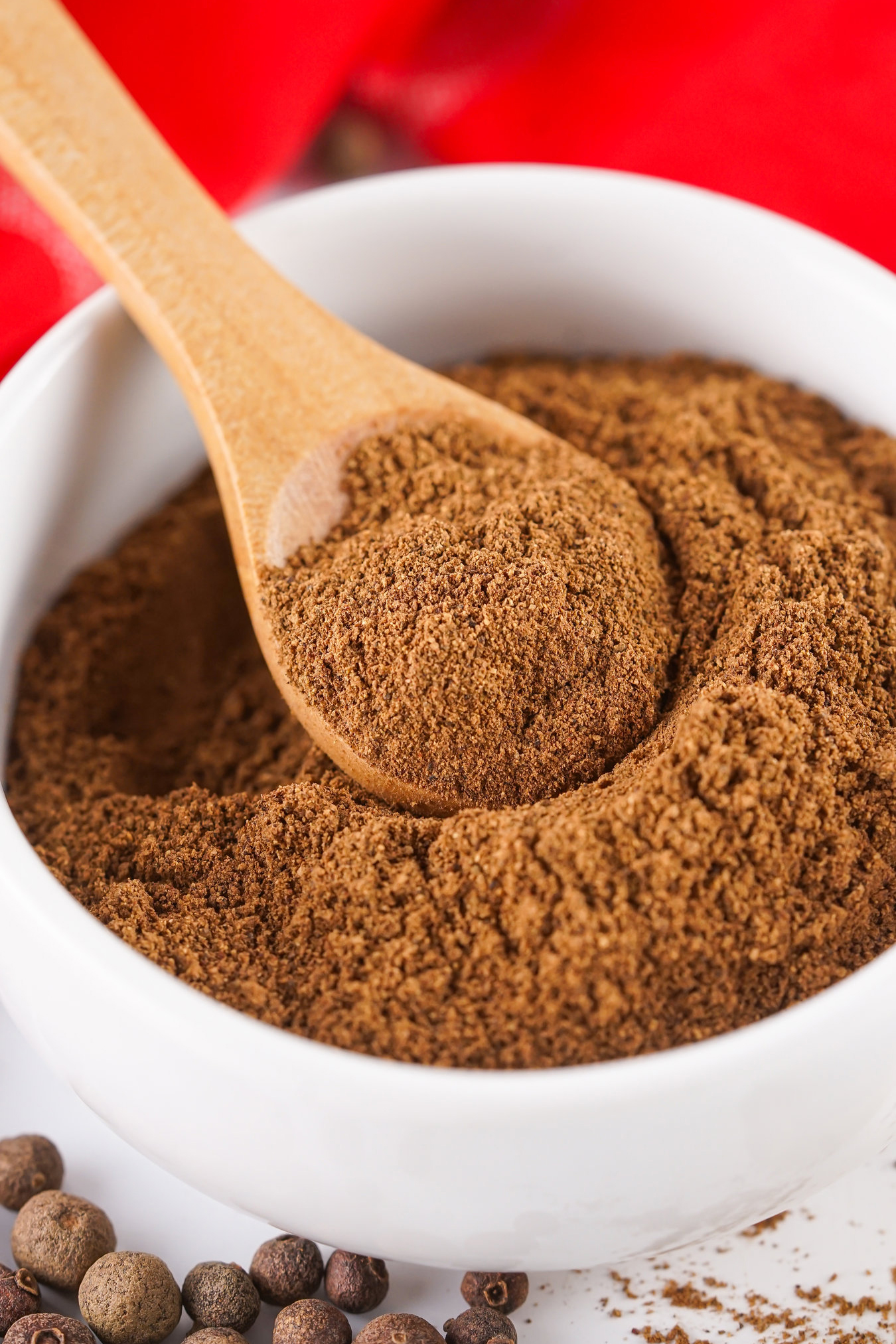 ground allspice in a bowl with a spoon