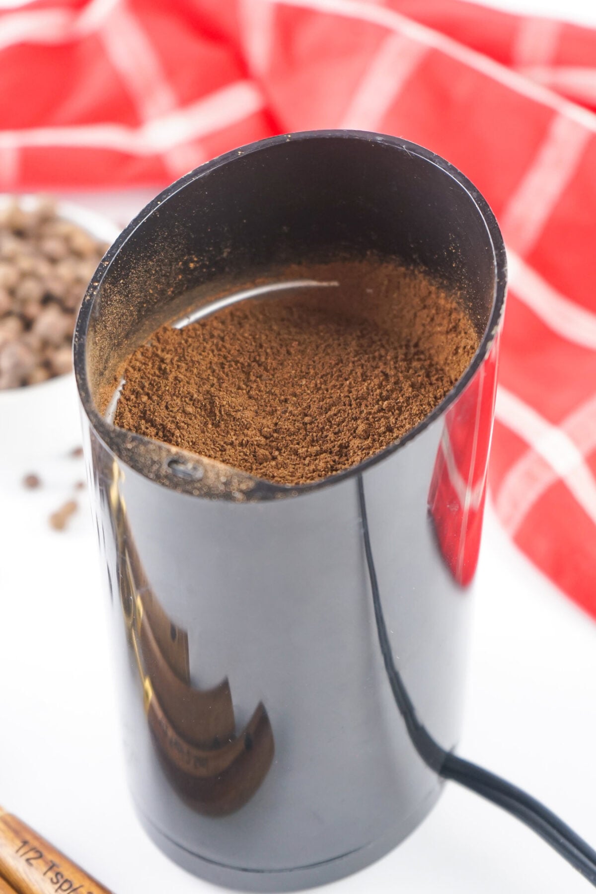 ground allspice in a spice grinder