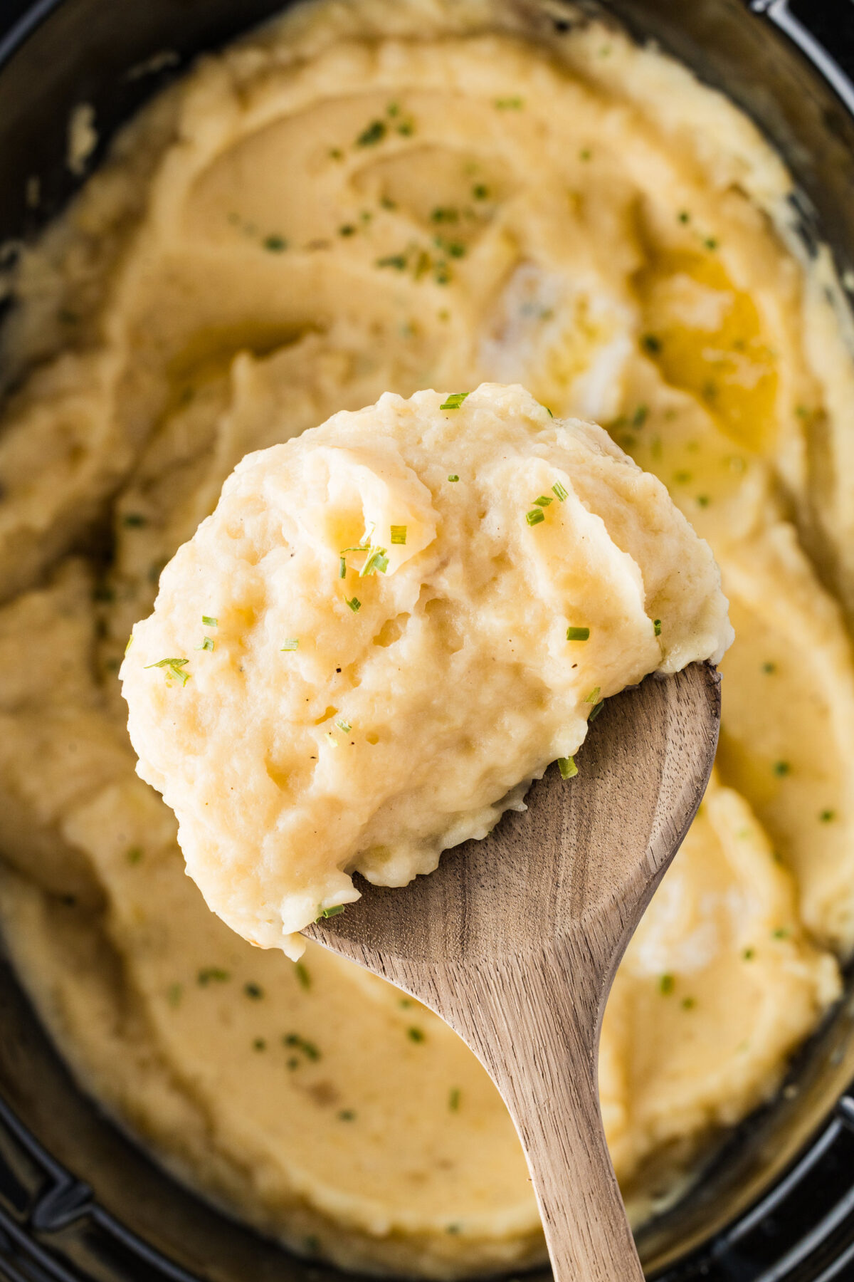 slow cooker mashed potatoes on a spoon