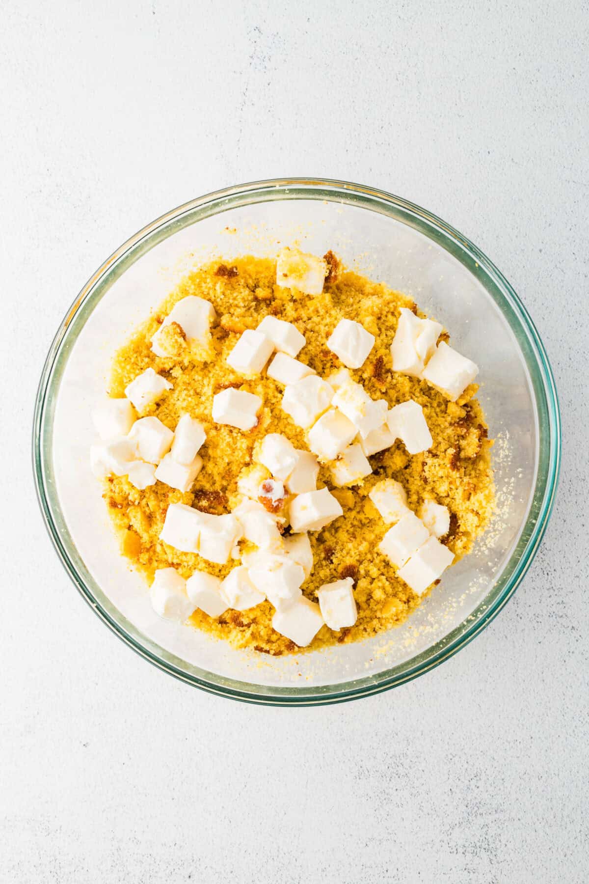 cubed butter in warm crumbled cornbread