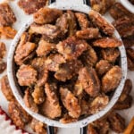 spiced pecans in a bowl and scattered around