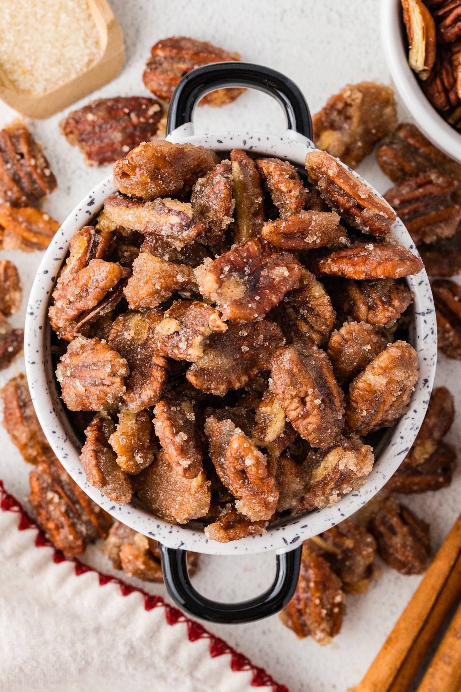 spiced pecans in a bowl and scattered around