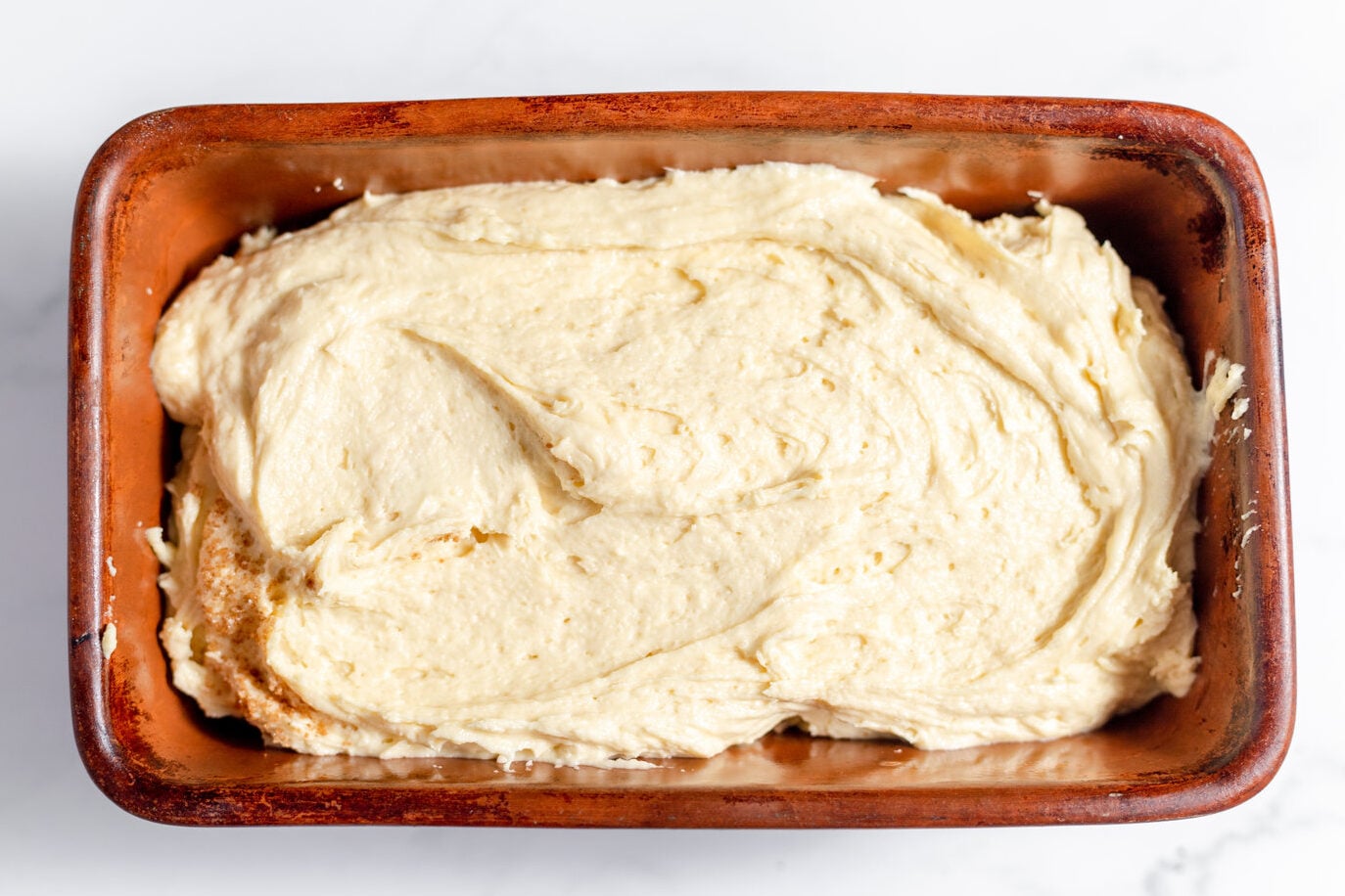 half the batter in a loaf pan