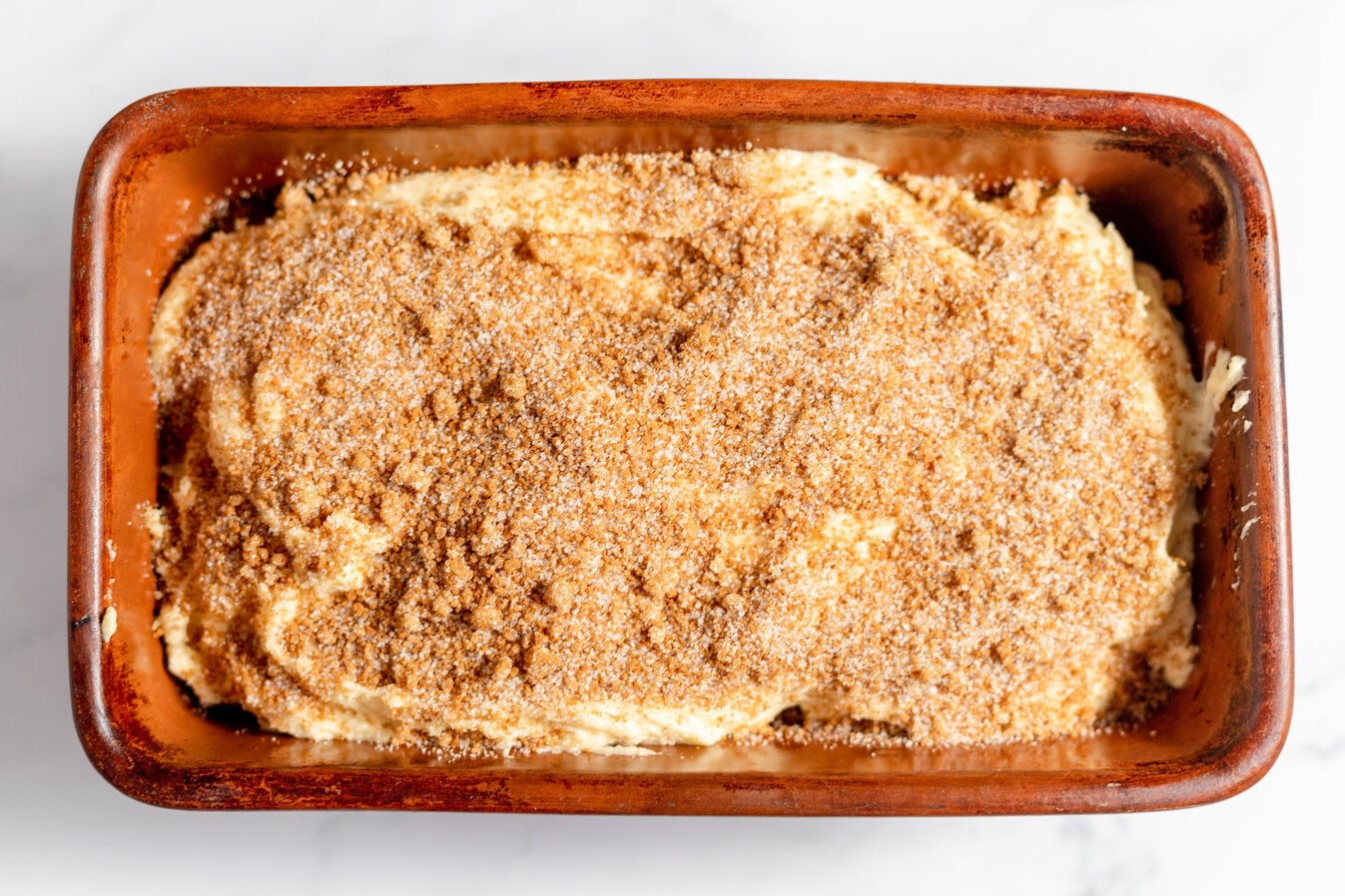 cinnamon sugar mixture over layer of dough