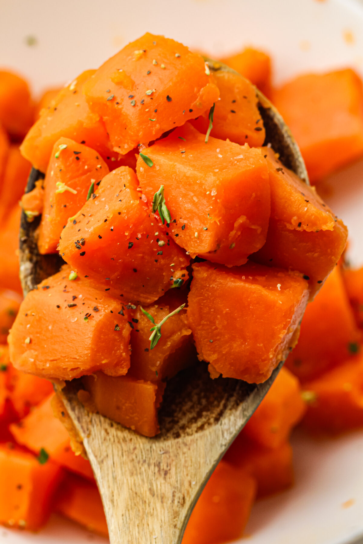 boiled sweet potatoes on a wooden spoon
