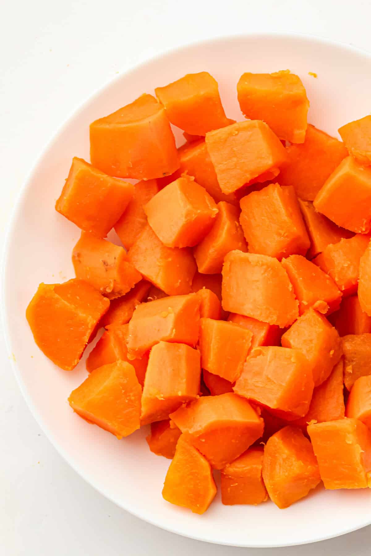 boiled sweet potatoes on a white plate