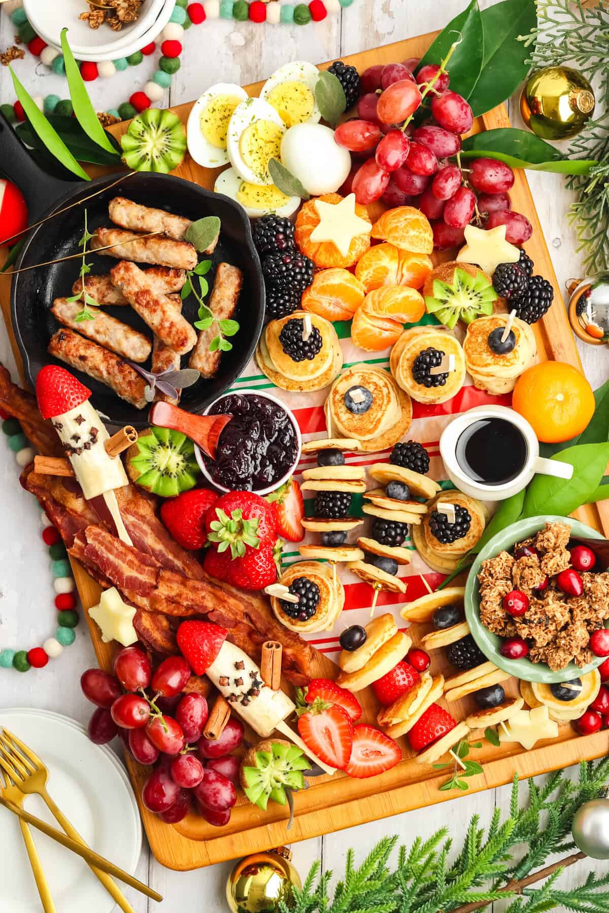 breakfast charcuterie board with mini pancakes and banana santa