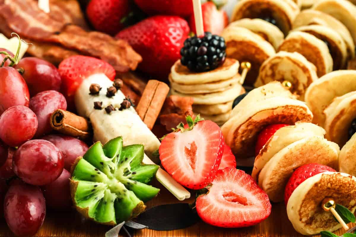 breakfast charcuterie board with mini pancakes and banana santa