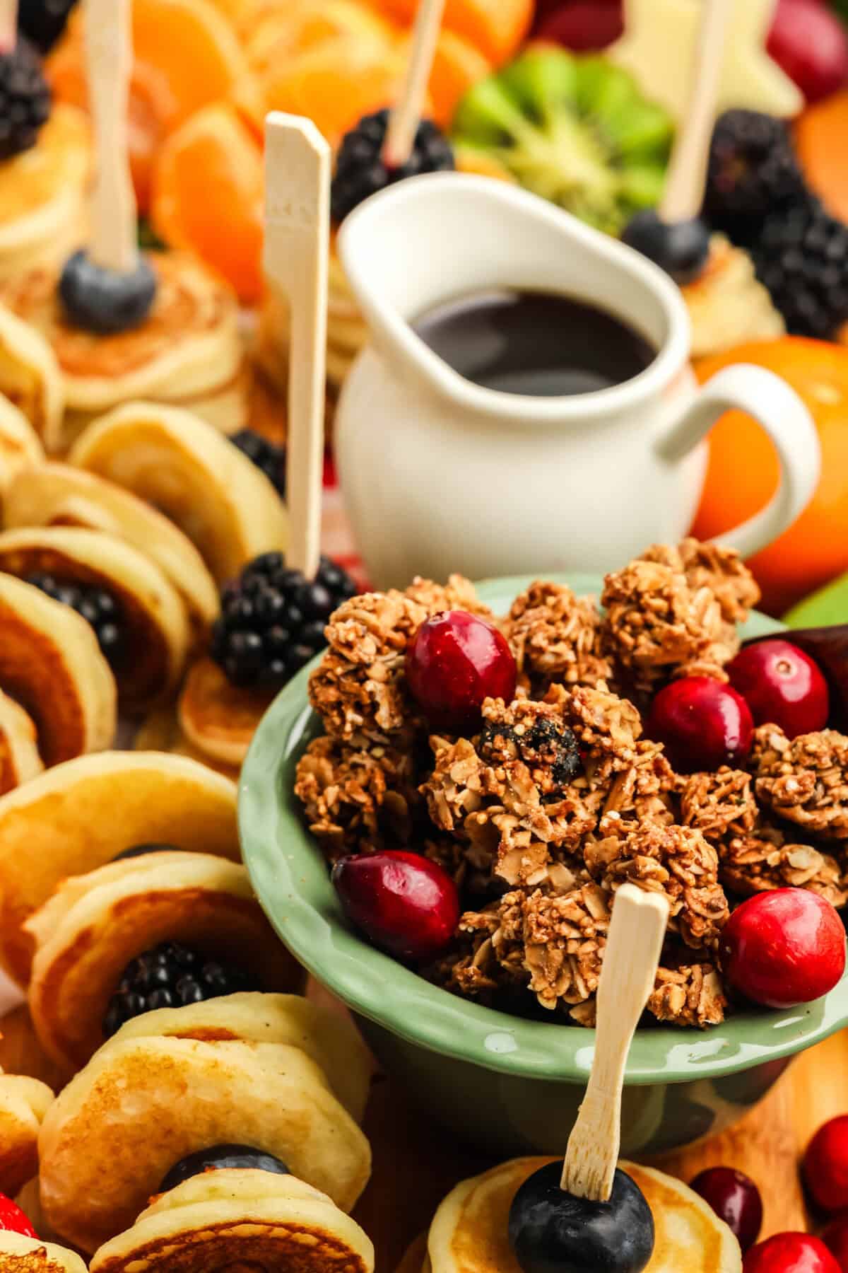 bowl of granola with cranberries on a brunch charcuterie board