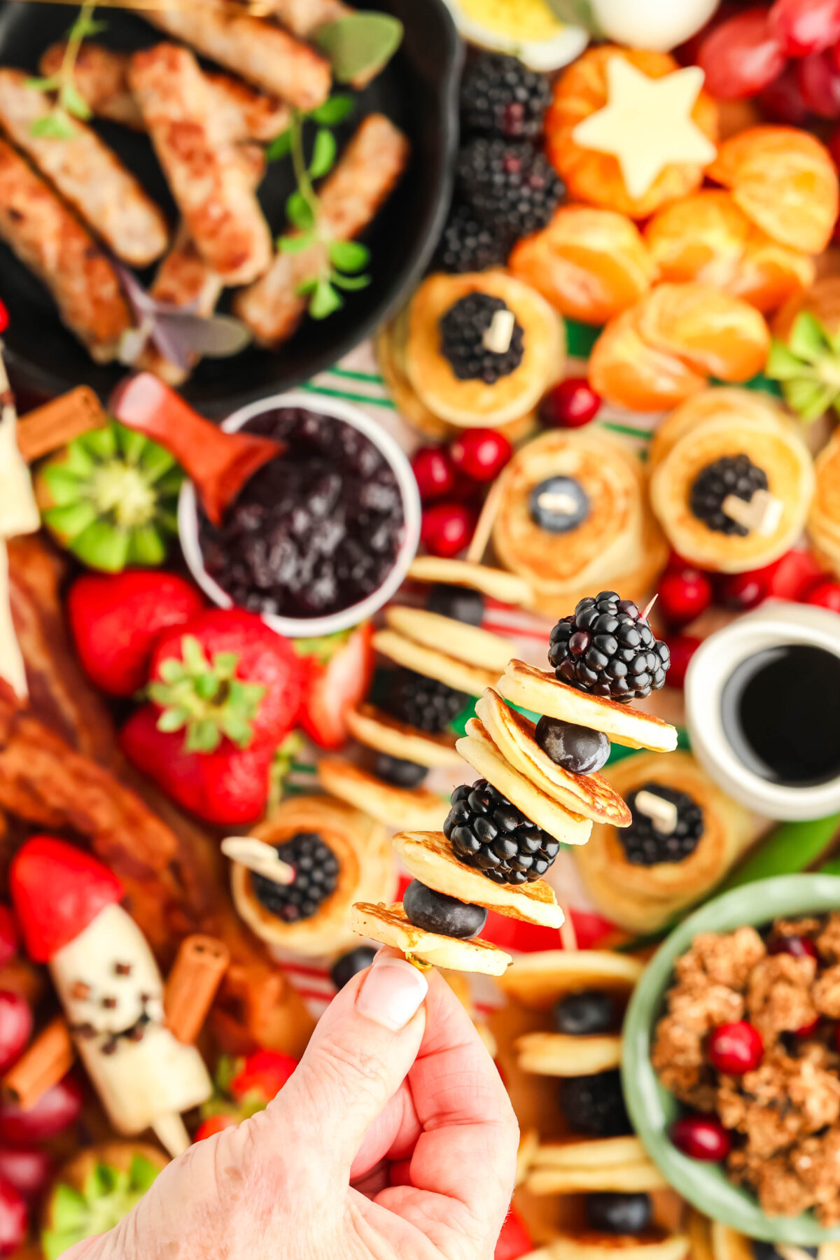 mini pancakes skewer over a breakfast charcuterie board