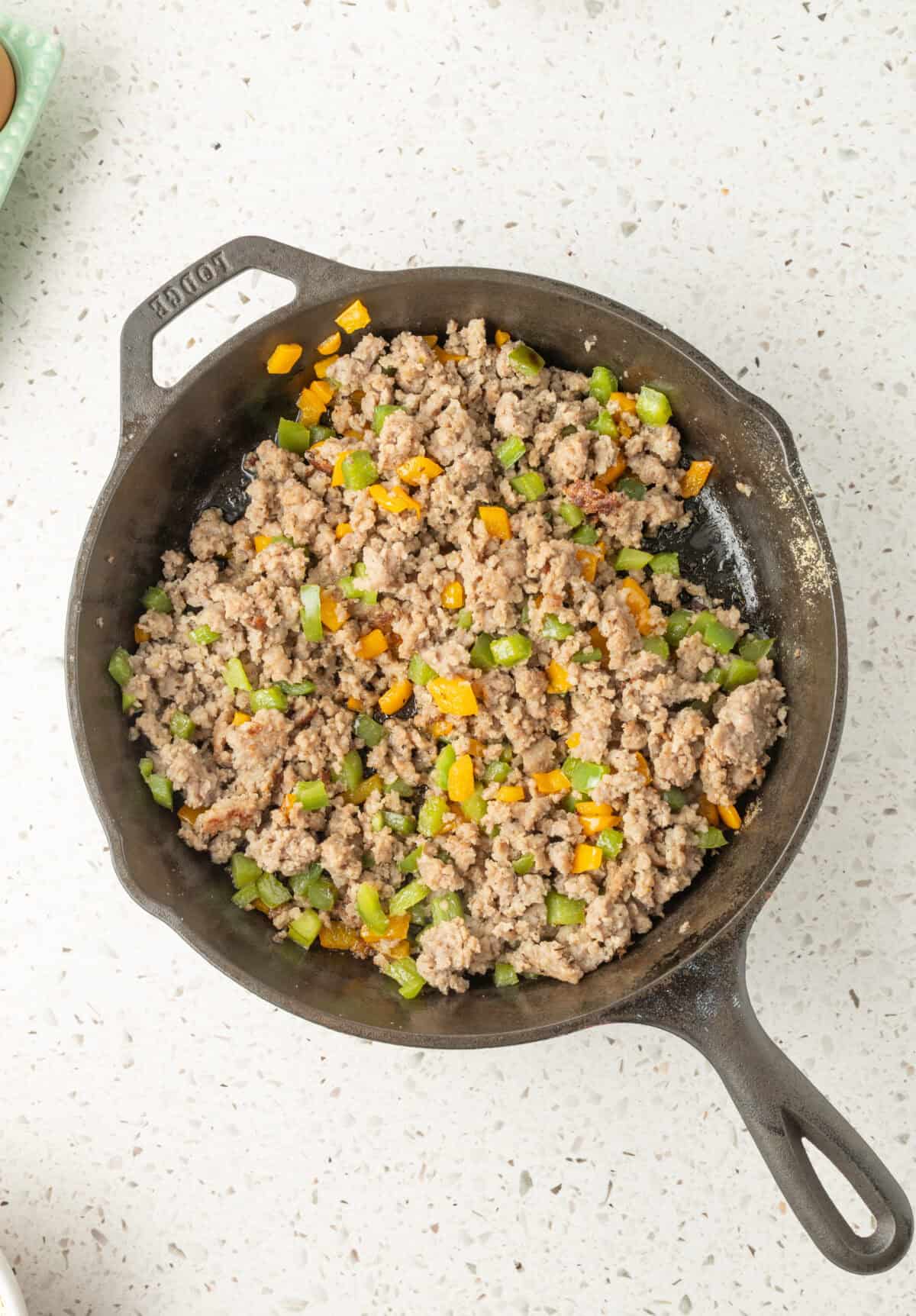cooked sausage and veggies in a skillet