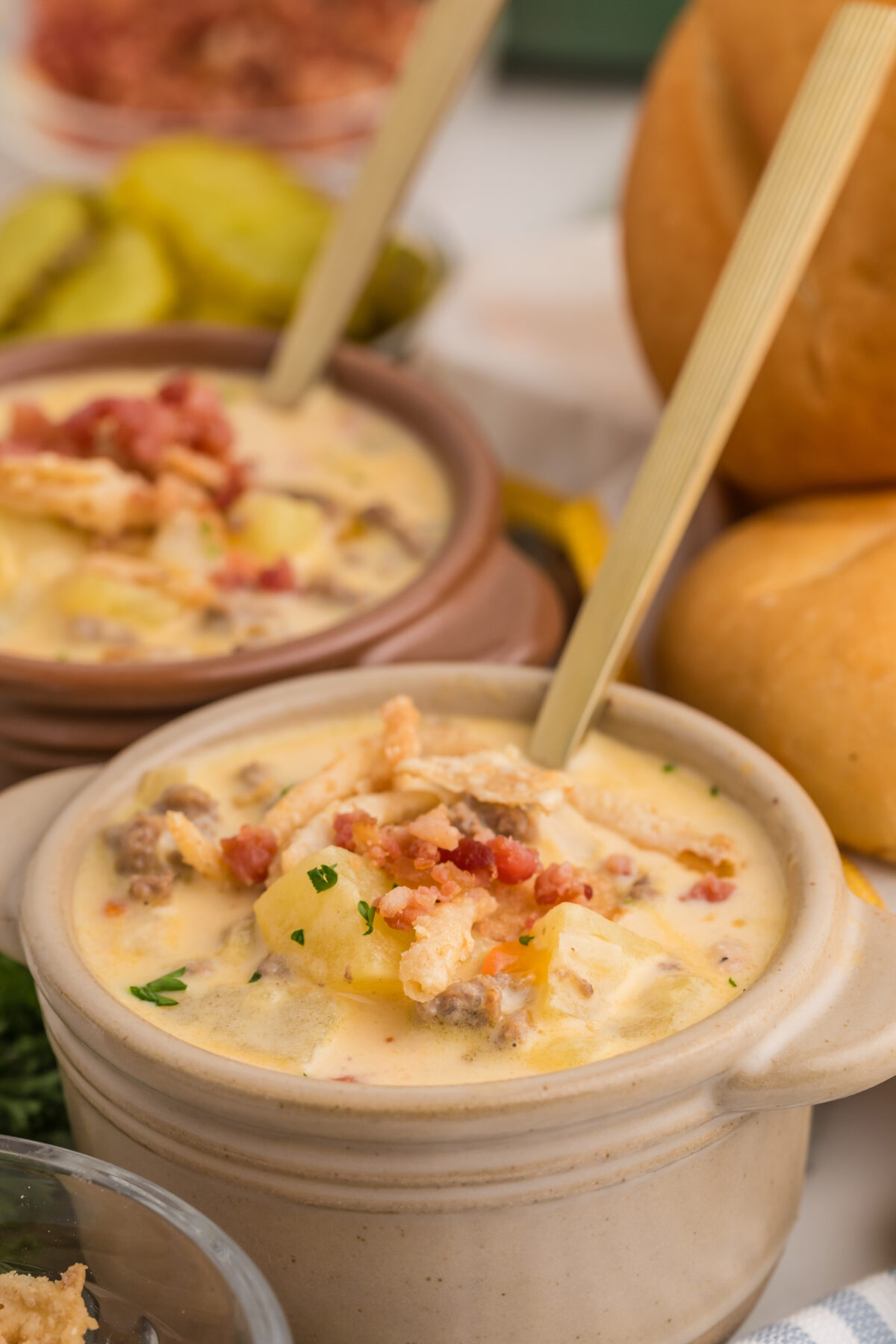 cheeseburger soup topped with crispy onions and bacon bits