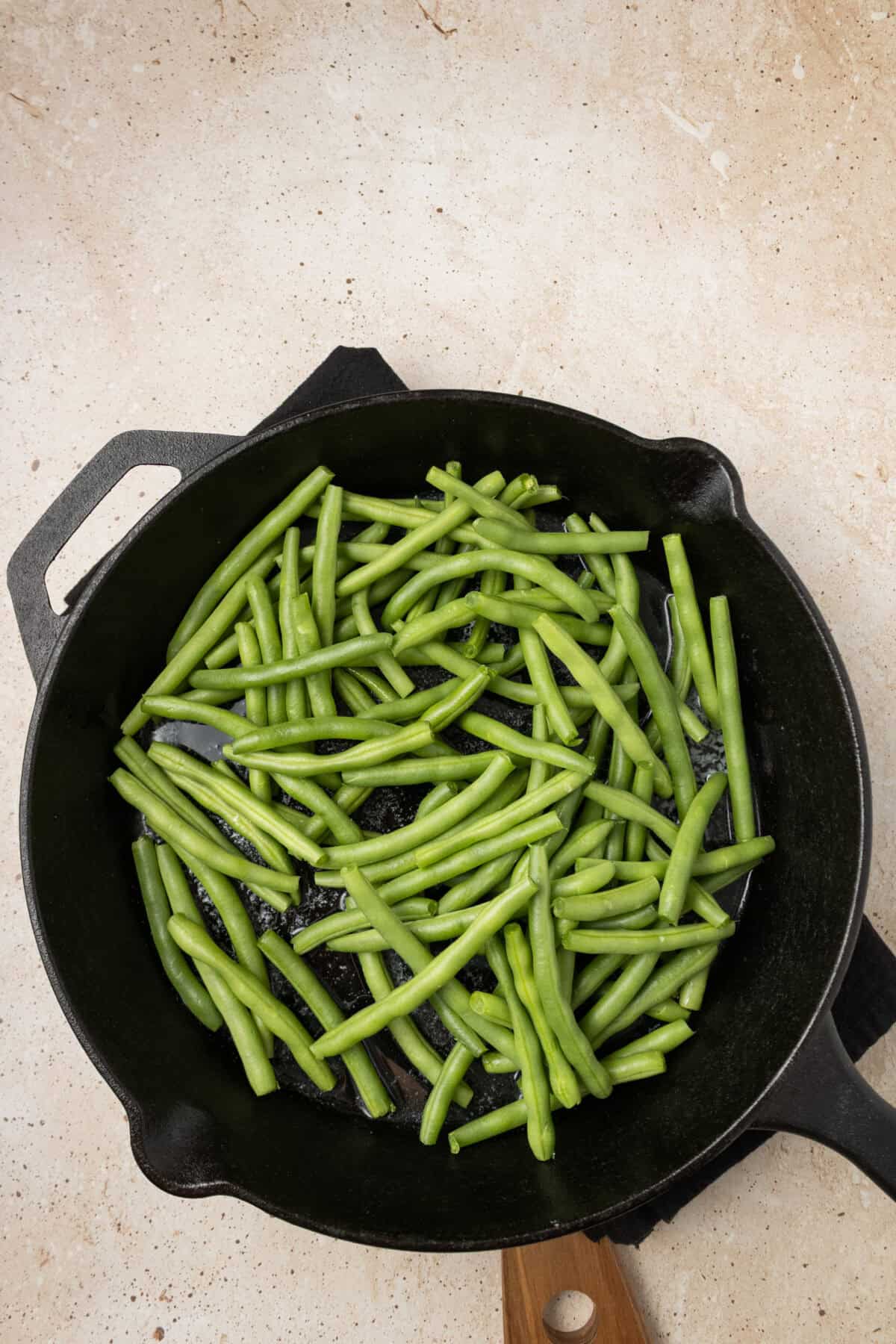 fresh green beans added to skillet