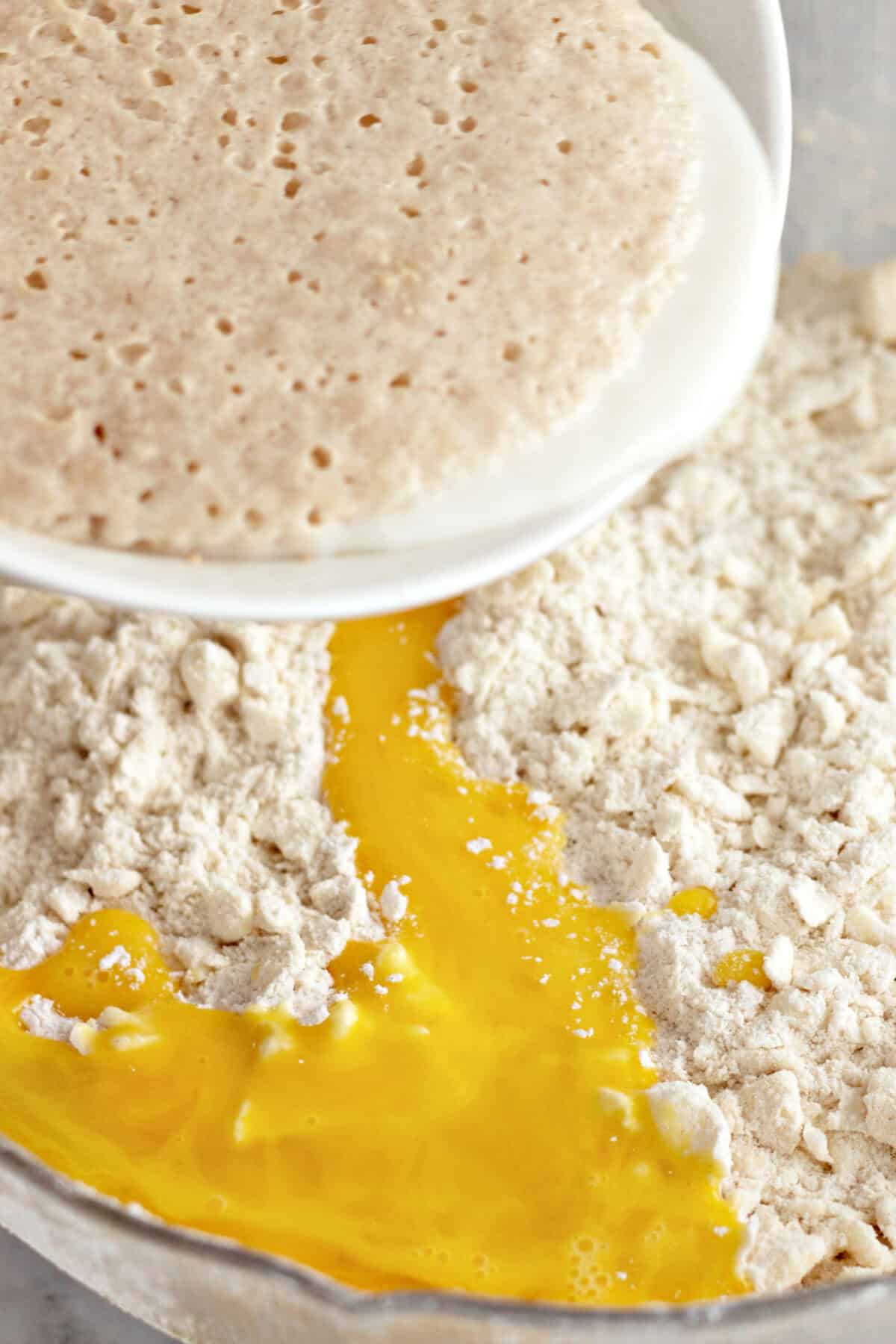 adding yeast and eggs to dry mixture