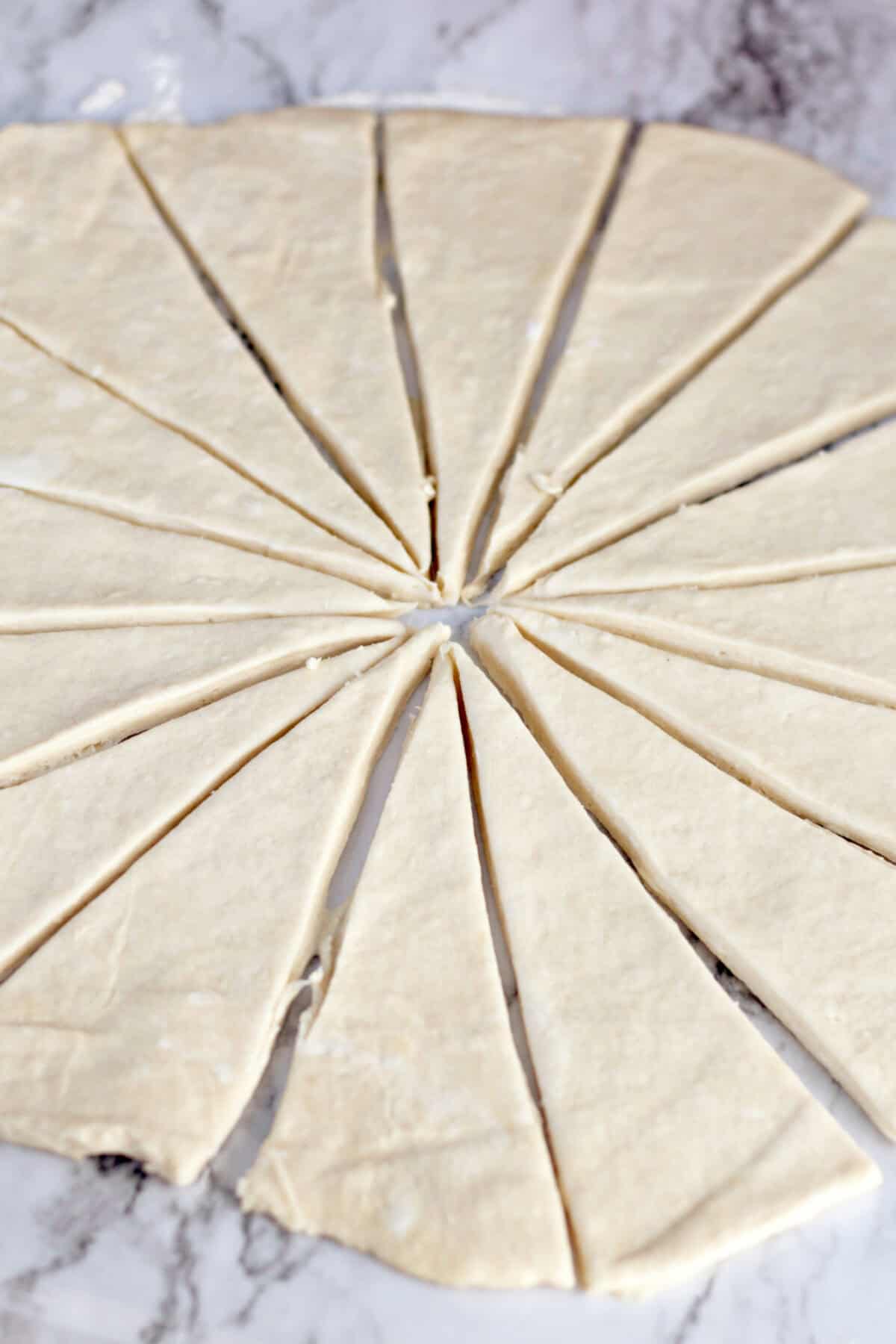 rolled out crescent dough cut into triangles