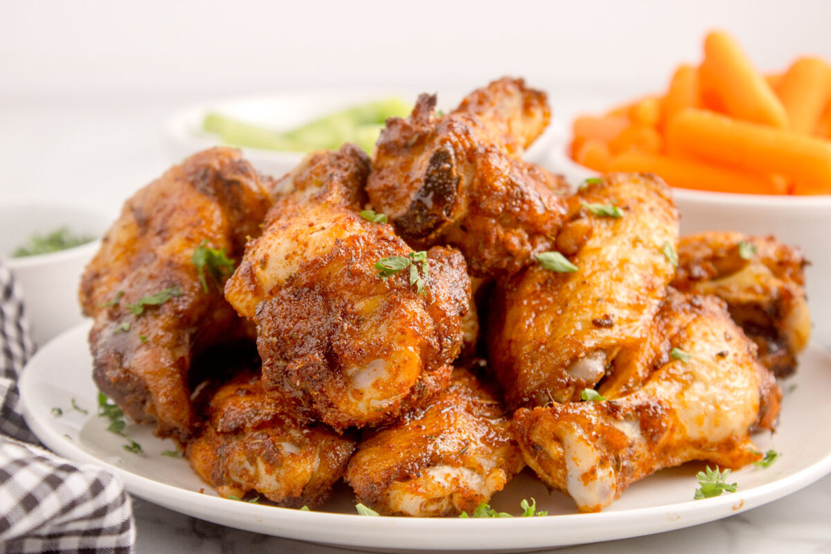 dry rub wings stacked on a plate