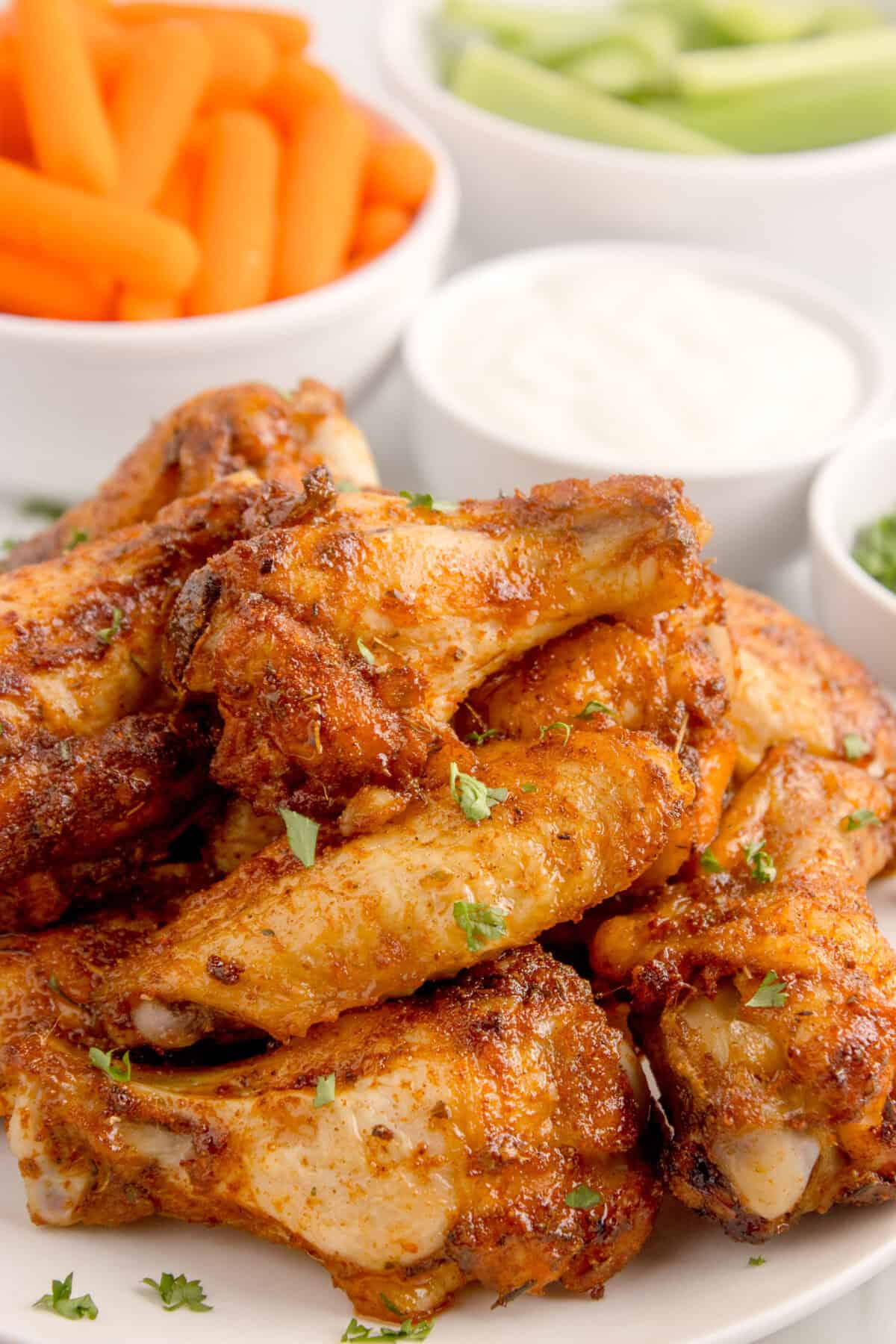 dry rub wings stacked on a plate
