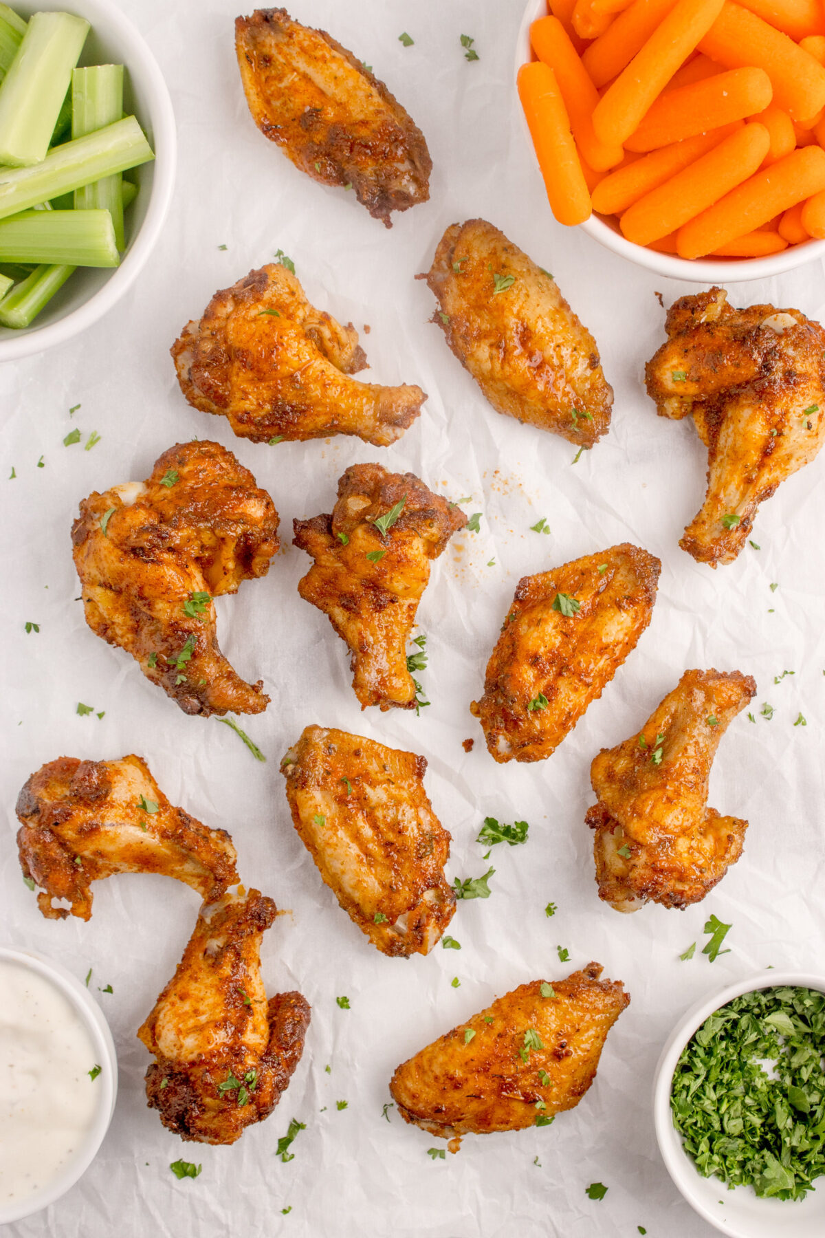 wings on a surface with celery and carrots