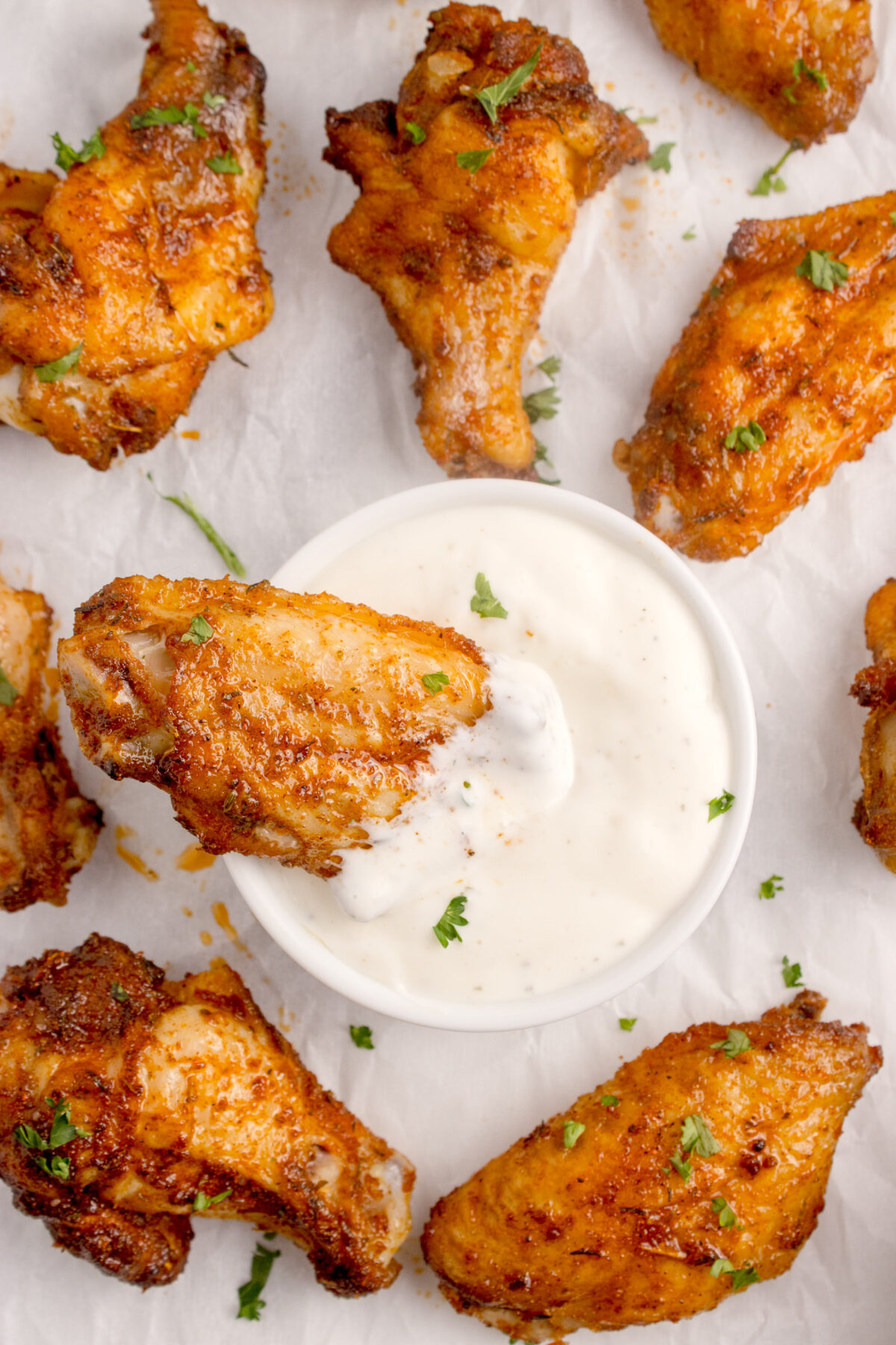wings being dipped in ranch or blue cheese dressing