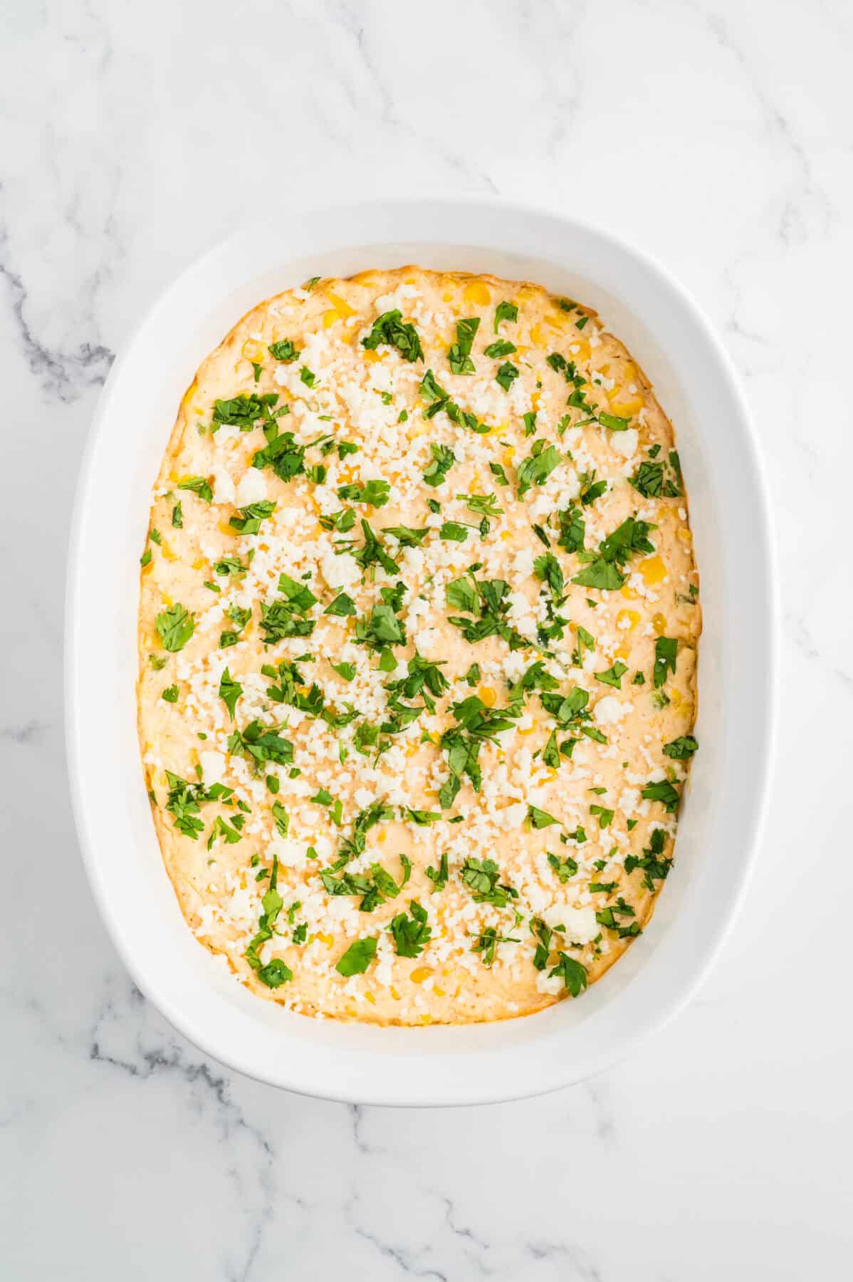 baked mexican street corn dip sprinkled with cojita cheese and cilantro