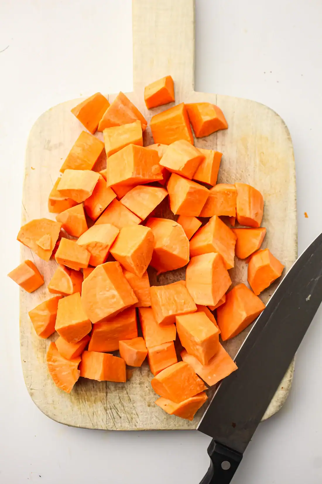 cubed sweet potatoes on a cutting board