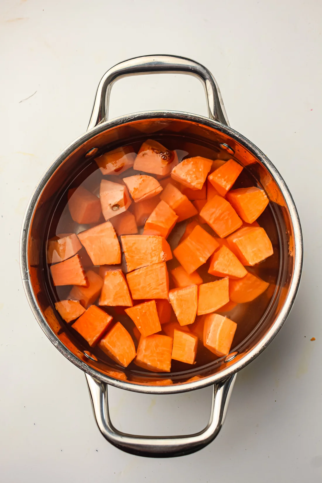 cubed sweet potatoes covered in water