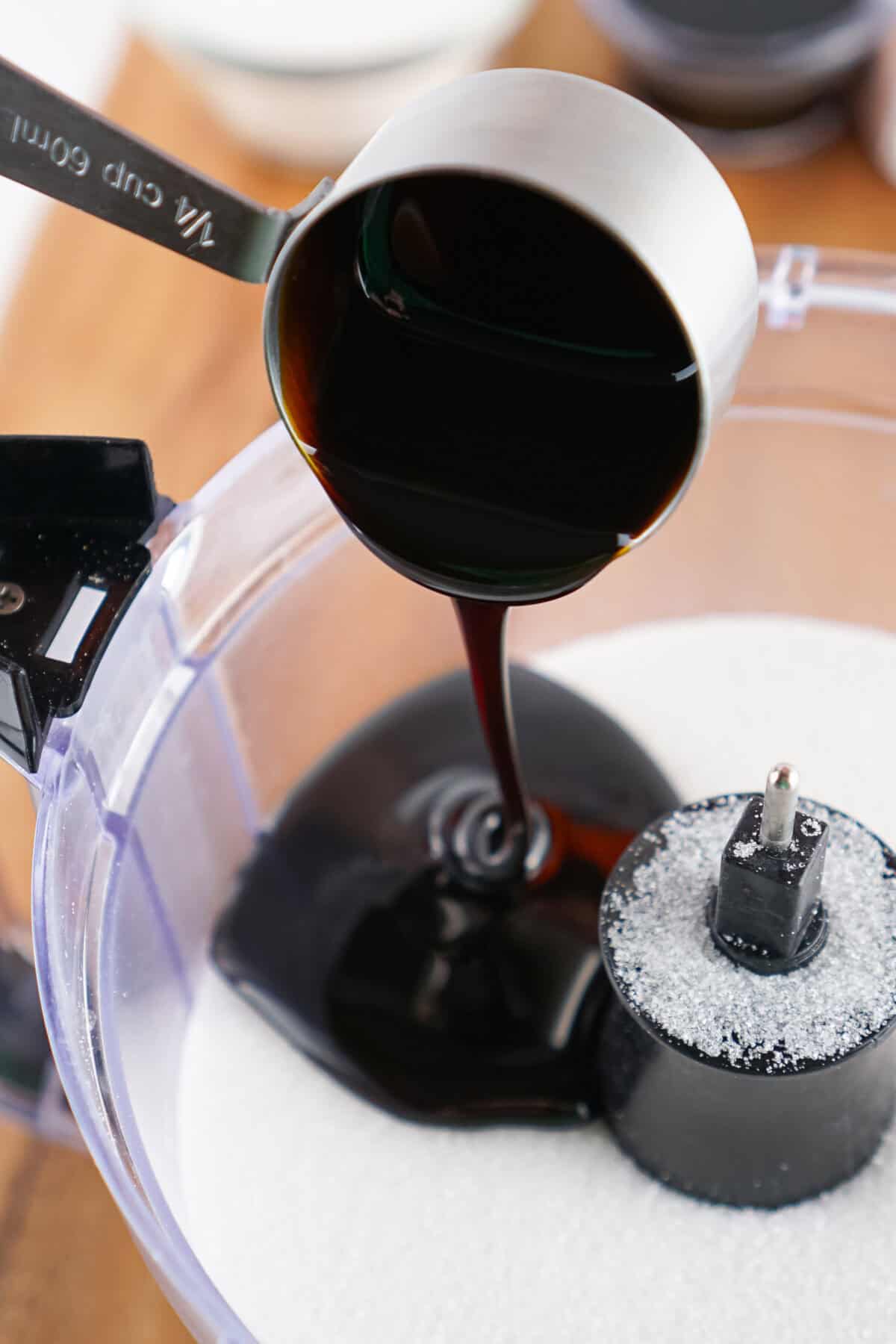 pouring molasses into sugar in food processor