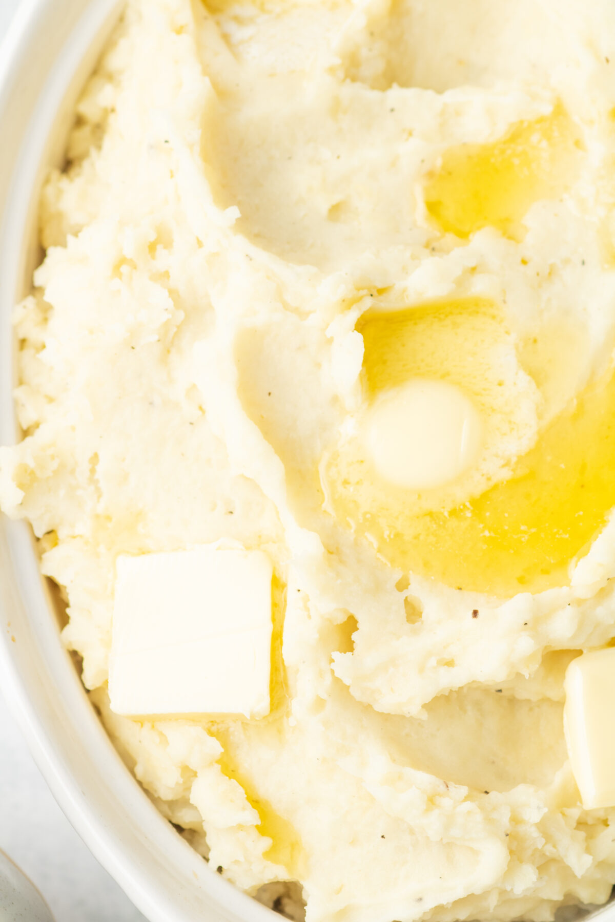 instant pot mashed potatoes with butter in a white dish