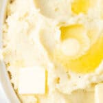 instant pot mashed potatoes with butter in a white dish