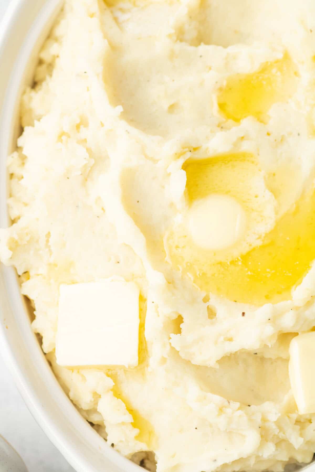 instant pot mashed potatoes with butter in a white dish